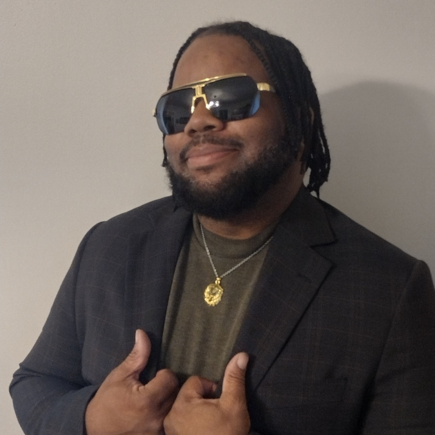 Eutoine wearing sunglasses and a dark blazer